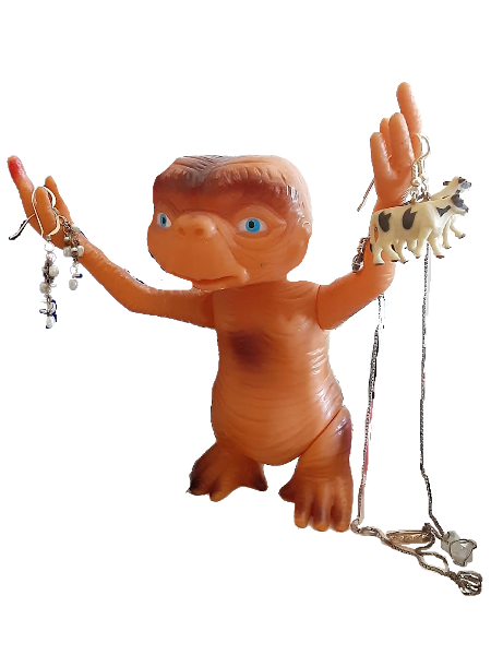 plastic E.T. figurine with earrings hanging from its hands