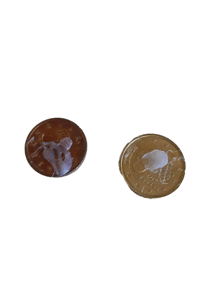 two coins with dried hot glue on them